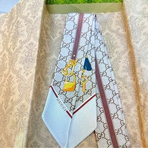 Gucci Silk Tie with Gold and Blue Accents